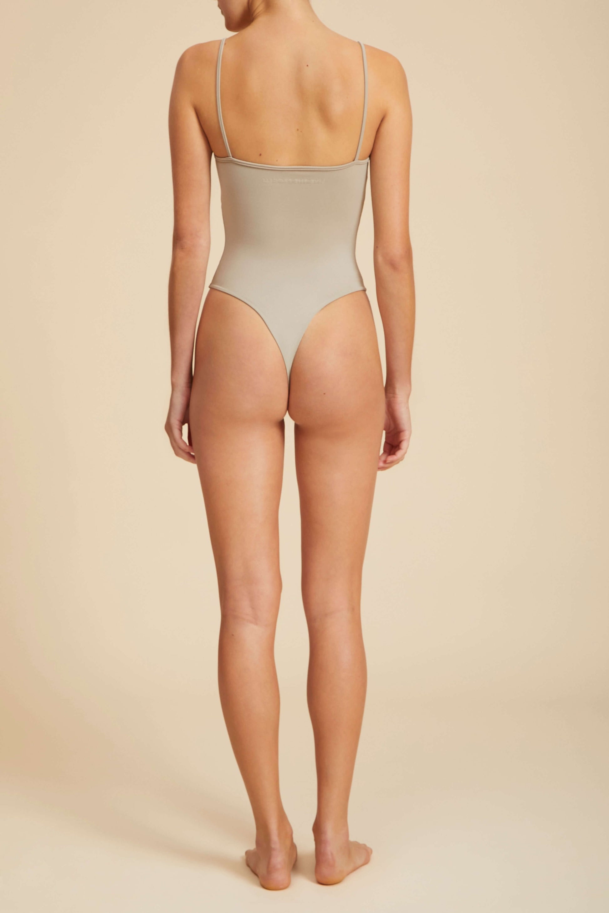 Live The Process Vega Leotard. Layer cake. Easy does it is the name of the game for our Vega Leotard. The essential featuring ruching at the bust and a thong bottom is just the thing to layer up and go.